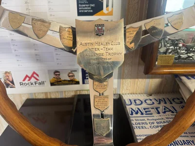 Steering Wheel boss showing the National Austin Healey Club Badge, and under, engraved: "Austin Healey Club Inter-Team Challenge Trophy presented by D.H. Worgan"